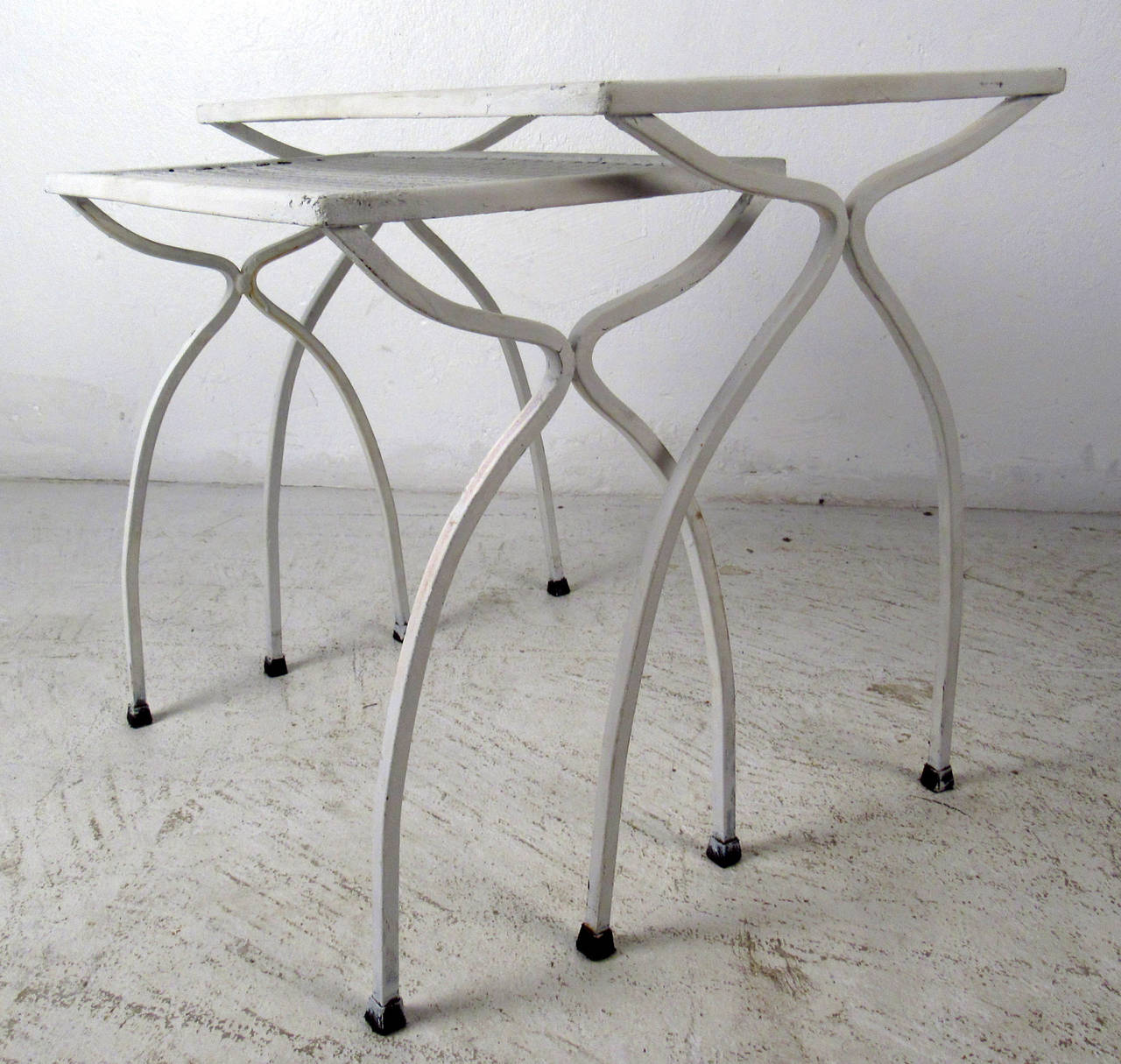 Vintage-modern set of industrial style nesting tables, features bent iron legs and mesh top, perfect for outdoor use.

Smaller table dimensions - 16.5W 10.5D 16.5H

Please confirm item location NY or NJ with dealer.