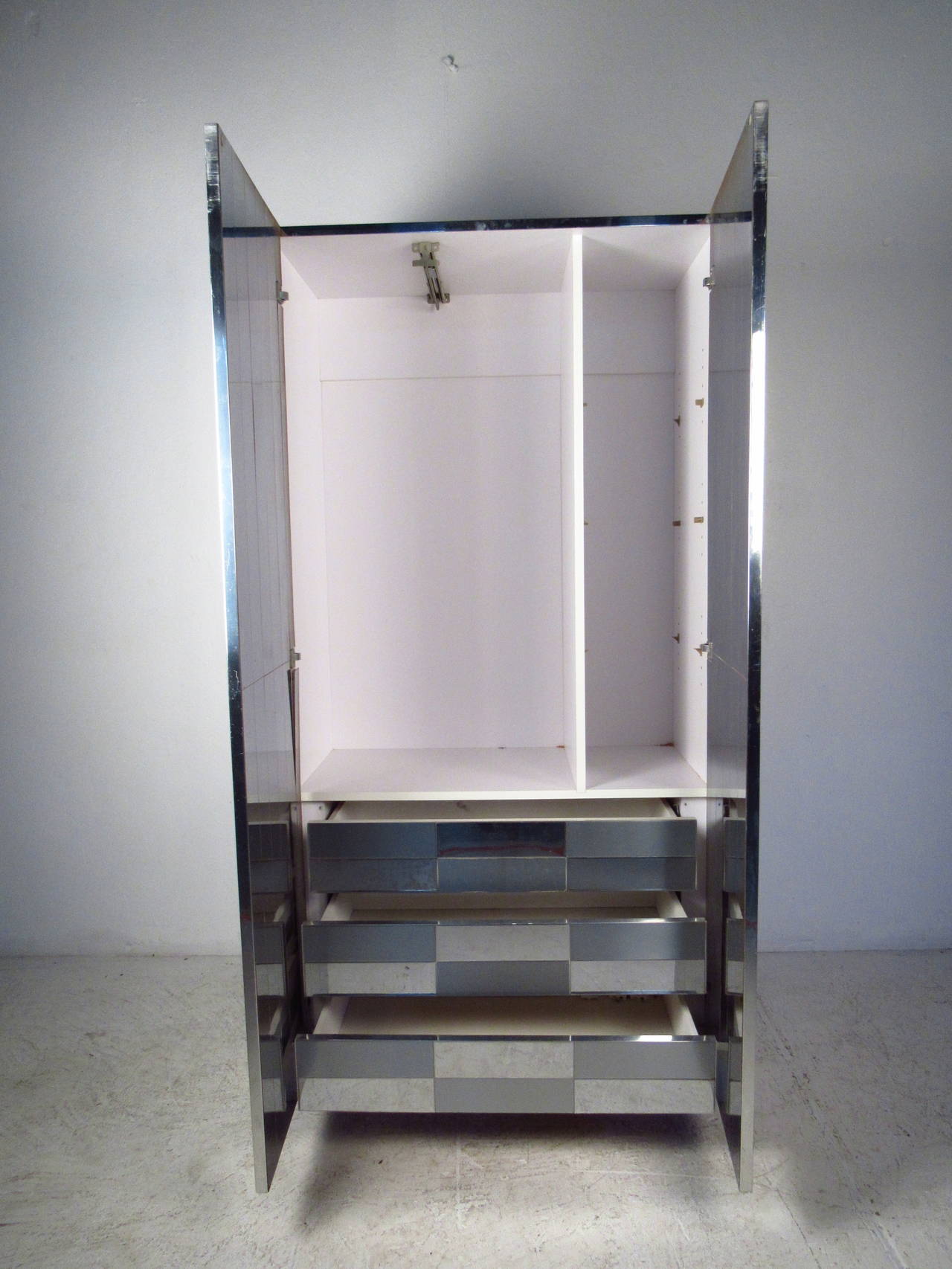 Tall cabinet with expanding coat rack, drawers and adjustable shelves. Polished and matte chrome strips throughout. 

(Please confirm item location - NY or NJ - with dealer).