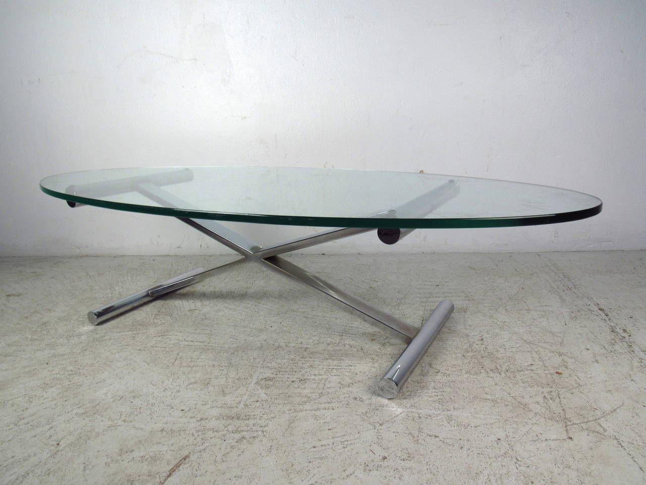 This midcentury coffee table features a half inch thick oval shaped glass top and tubular chrome base which offers a modern flare to any home or office.

Please confirm item location (NY or NJ) with dealer.
