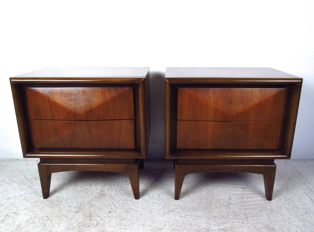 This beautiful pair of sculpted front nightstands features a unique diamond front design, wonderfully complimented by rich walnut finish, tapered legs, and gorgeous mid-century style. Please confirm item location (NY or NJ).