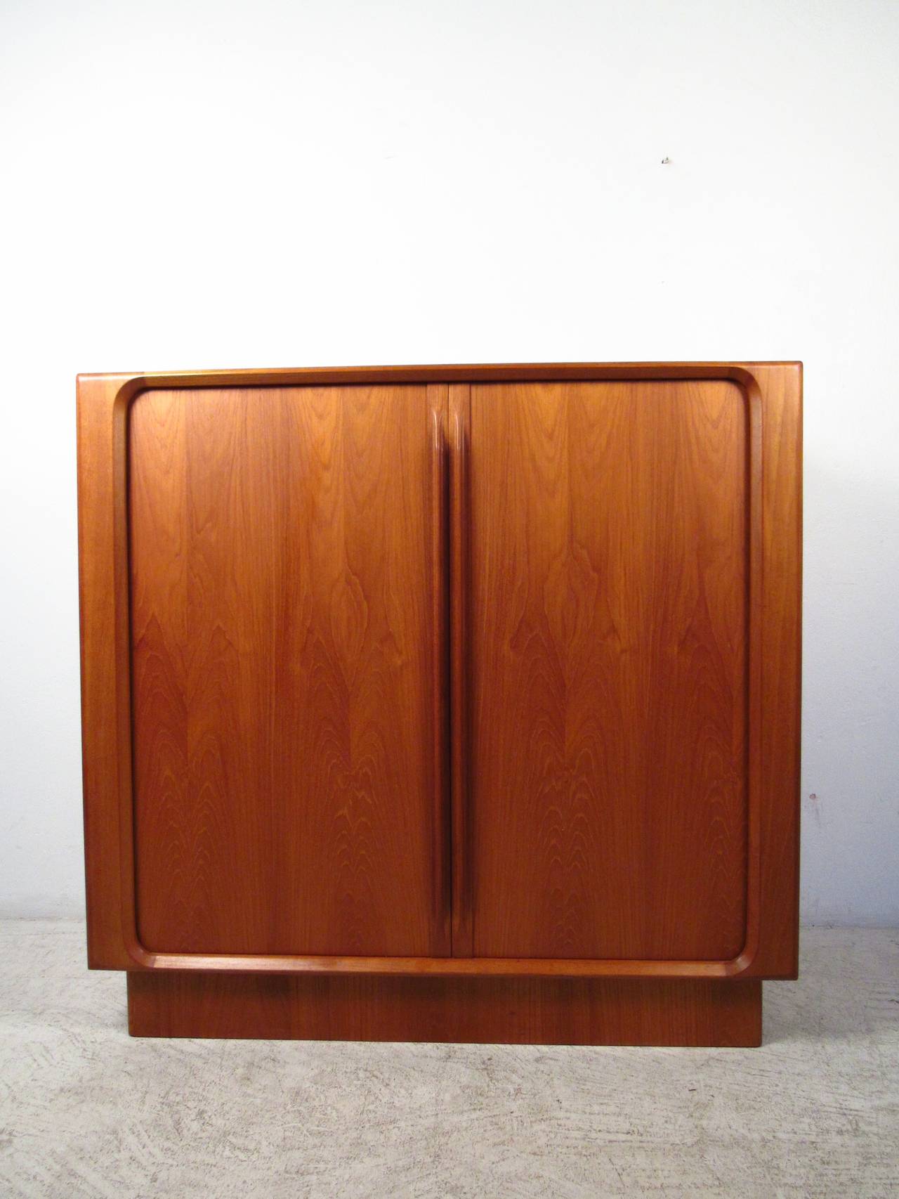 This beautiful mid-century style tambour front chest was wonderfully crafted by Bernhard Pedersen & Sons, and offers plenty of storage in a stylish package. Wonderful teak finish, quality craftsmanship, and finished back set this piece apart from