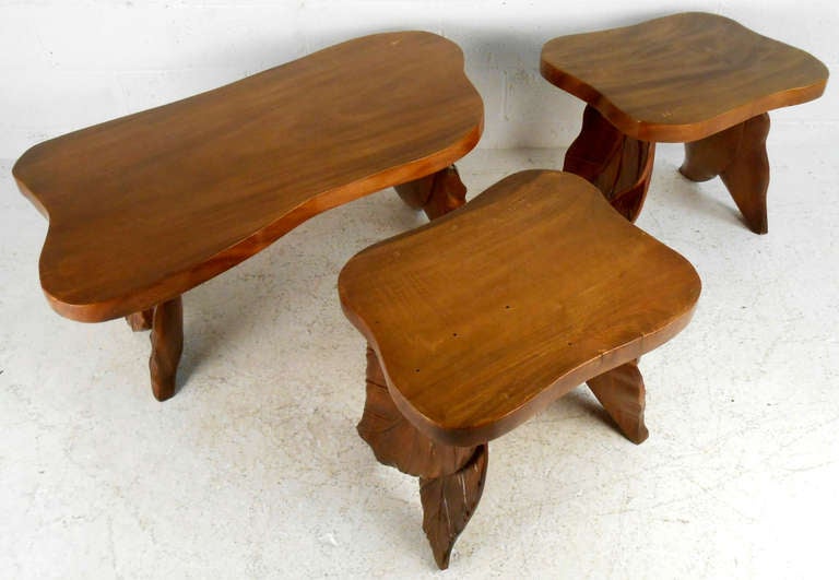 This walnut table set includes a coffee table and pair of side tables, all featuring matching hand-carved leaf-motif legs. This sculpted hardwood set of living room tables make an impressive and memorable addition to any interior. Unique set of