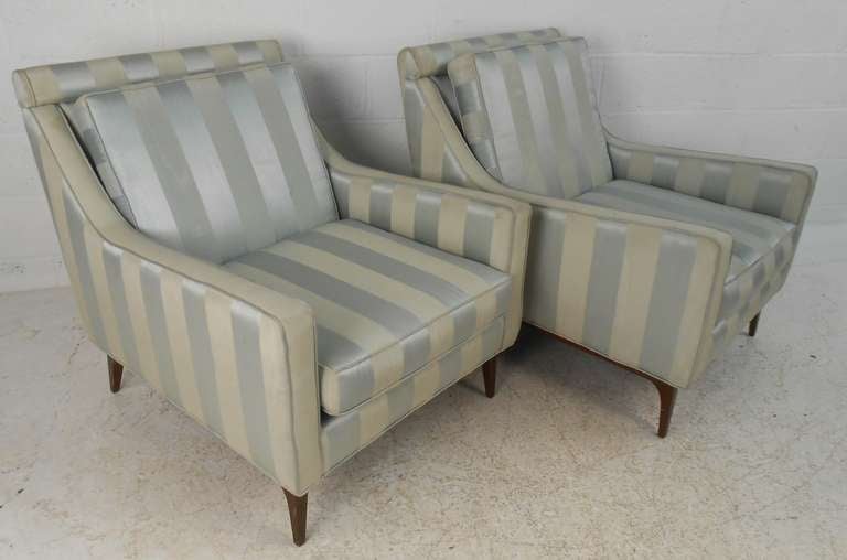Pair of upholstered lounge chairs in the style of Paul McCobb. Please confirm item location (NY or NJ) with dealer.
