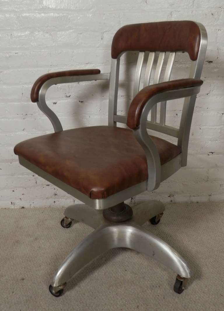 Adjustable swivel arm chair by the Good Form company out of Ohio. Solid metal construction, almost unbreakable. Original vinyl is still in good condition, adjusts and swivels with original casters. 

(Please confirm item location - NY or NJ - with