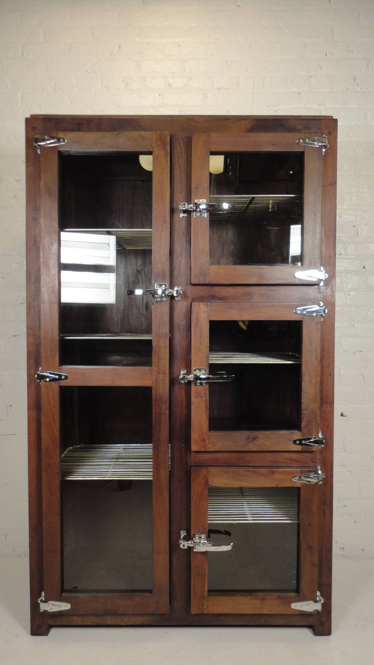 Super vintage style cabinet made of refurbished materials. Solid stained lumber and large polished hardware. Includes 5 metal grate shelves, that can be removed. Makes an awesome kitchen cabinet or large armoire style bedroom wardrobe.

(Please