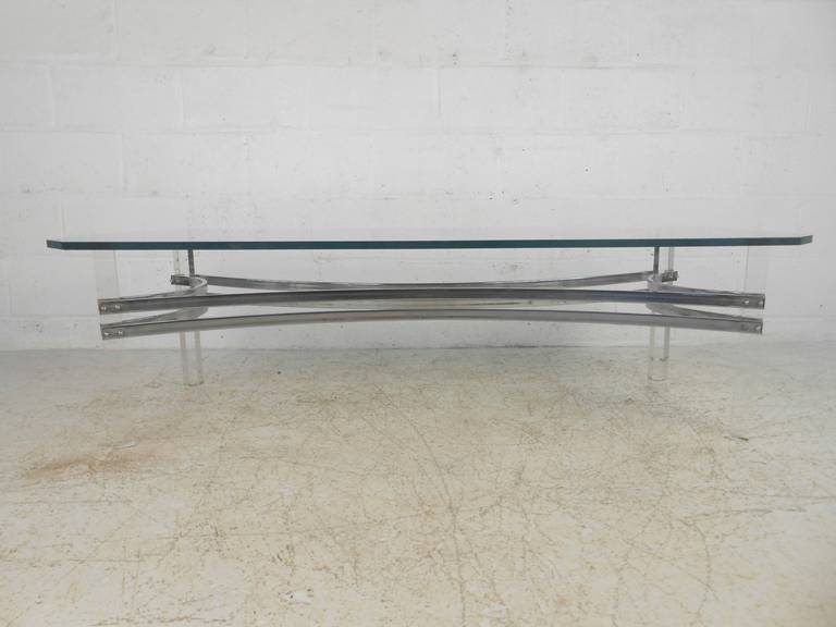 This Mid-Century Modern coffee table features unique Lucite and chrome base in the style of Charles Hollis Jones. Stylish vintage table perfect for home or business cocktail table.

Please confirm item location (NY or NJ) with dealer.