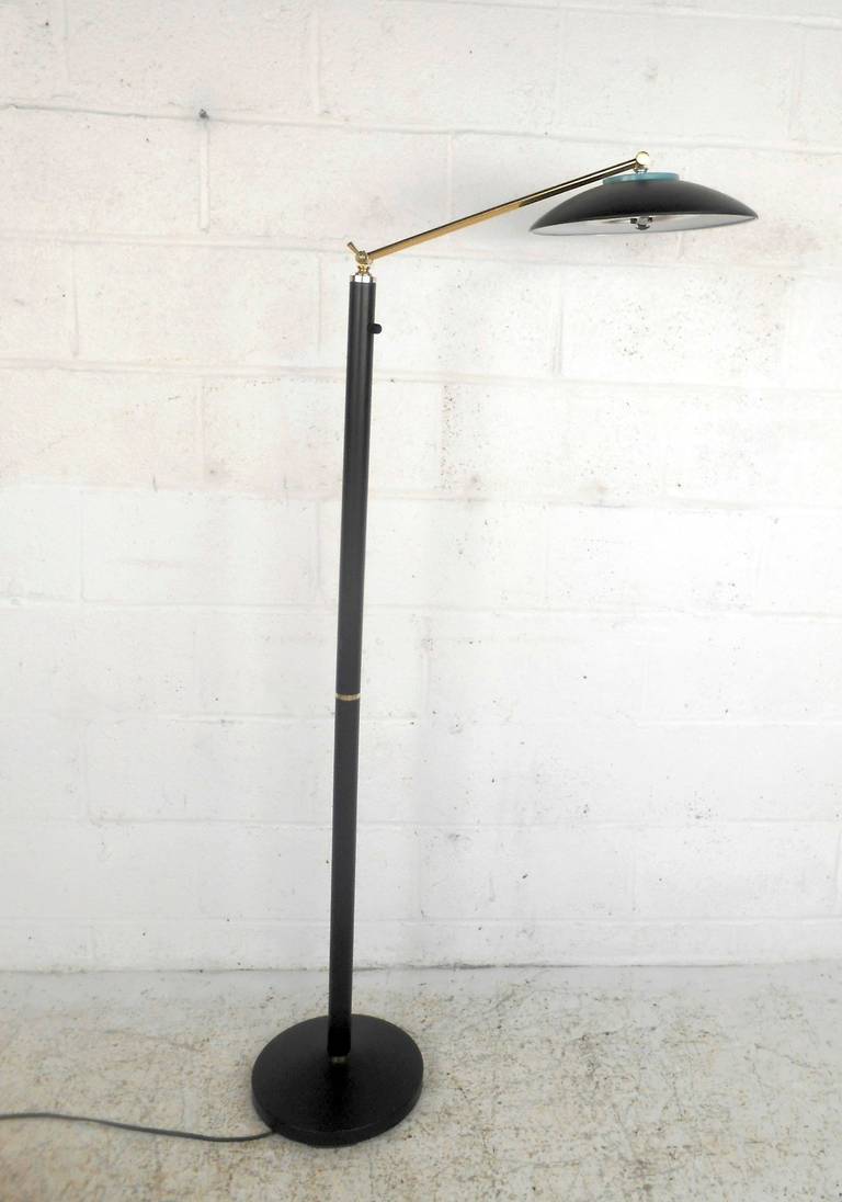 This modern floor lamp features an adjustable neck, dimmer switch, and matte black finish with brass accents. 

Please confirm item location (NY or NJ) with dealer.