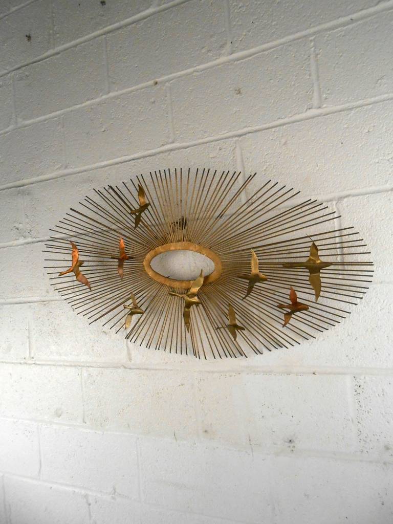 This wall sculpture in the style of Curtis Jere features a beautiful brass sunburst with bird silhouettes.

Please confirm item location (NY or NJ) with dealer.