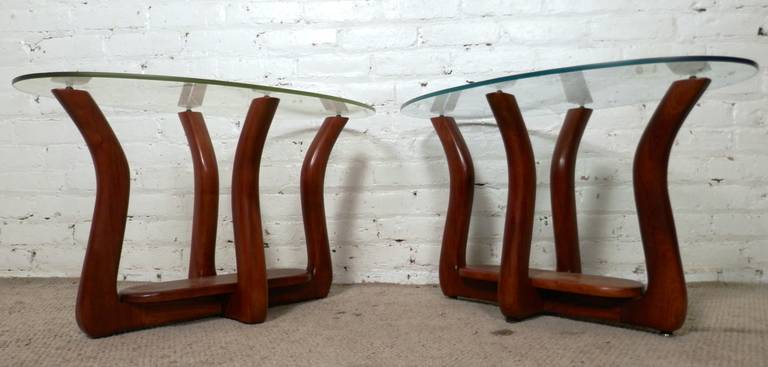 Very rare pair of oval glass top side tables with sculpted walnut bases. Unusual size and shape, great for sofa side tables.

(Please confirm item location - NY or NJ - with dealer).