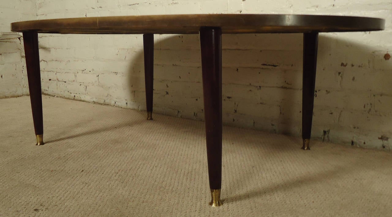 Vintage coffee table with unique construction, marble top affixed to cross woven re-bar with fiberglass, features rich mahogany legs, brass feet and trim.

Please confirm item location NY or NJ with dealer.