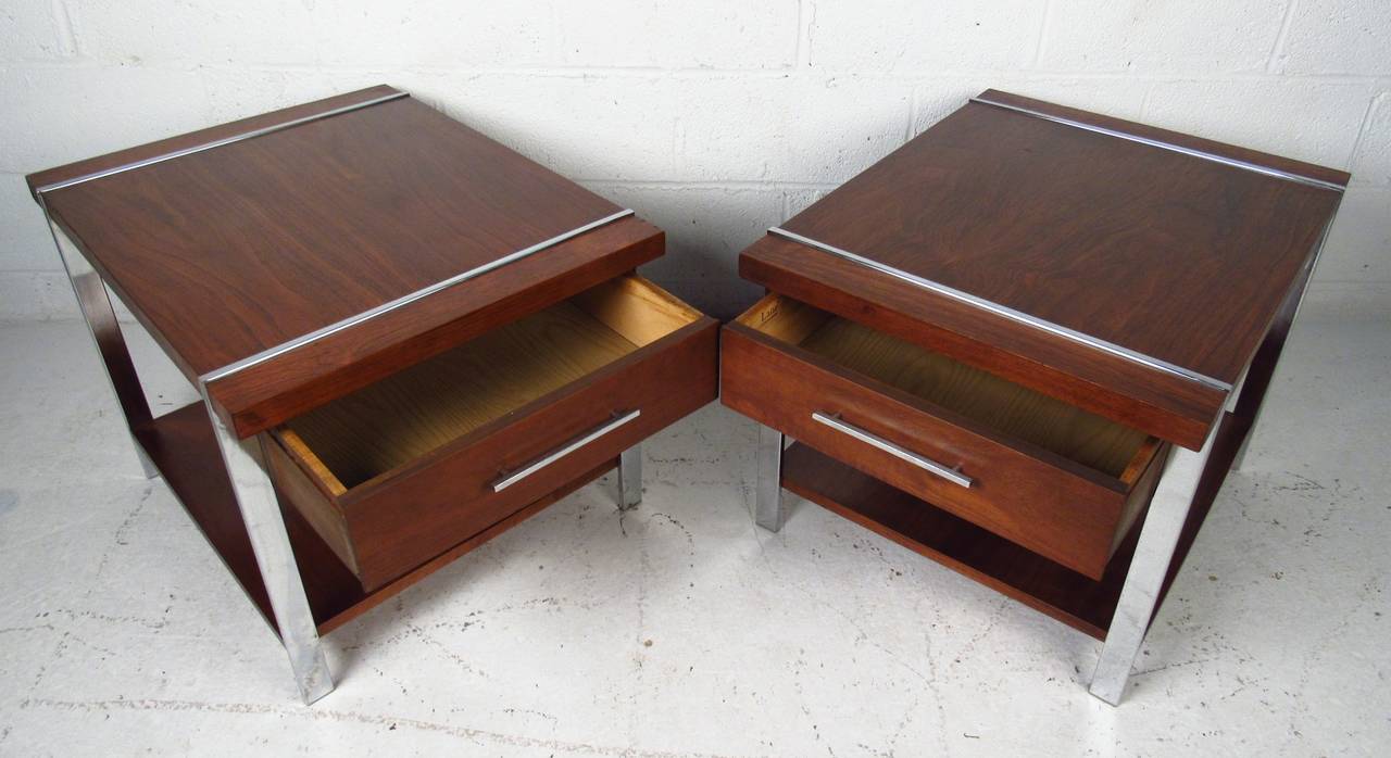 Pair of single drawer, two-tier chrome and walnut end tables by Lane. A sleek design with a finished back and dovetailed drawers. This pair of vintage modern side tables make the perfect addition to any modern interior. Please confirm item location