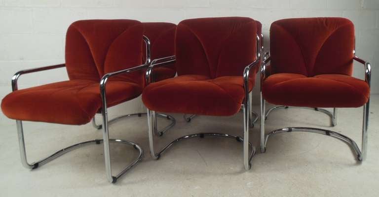 Set of six upholstered dining chairs with tubular metal frames make a stylish midcentury addition to dining room or kitchen seating. Plush seats and cantilever frames adds to the unique appeal of the set. Please confirm item location (NY or NJ) with