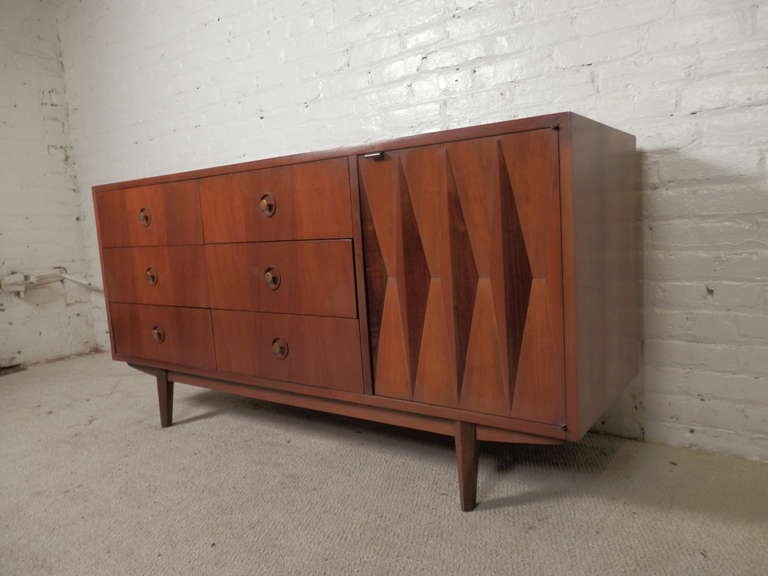 Mid-century modern six drawer dresser with cabinet storage beneath a beautiful sculpted front. Original brass pulls, small tapered legs. Perfect as a bedroom dresser, or living room credenza.

(Please confirm item location - NY or NJ - with dealer)