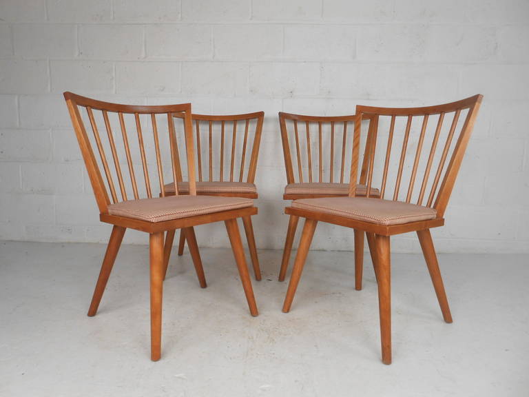 Set of four Mid-Century Modern Windsor style maple dining chairs by Leslie Diamond for Conant-Ball with stamp. Stylish and sturdy spoke back maple chairs with upholstered seats make the perfect addition to kitchen or dining room seating. 

(Please