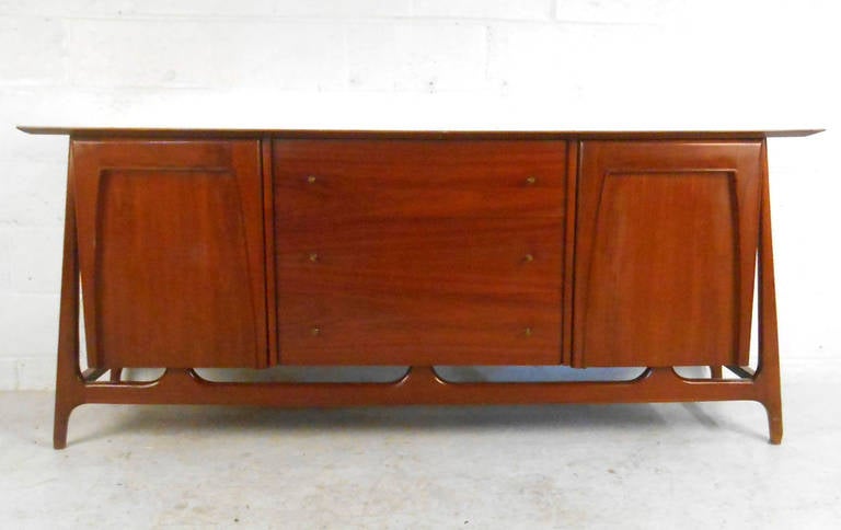 This beautiful Piet Hein dresser is a great solution for storage in home or business. With Mid-Century style drawer pulls and unique sculpted legs, this long vintage dresser makes a wonderful addition to any room. Please confirm location (NY or NJ).