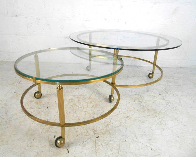 This rare pivoting brass coffee table features two-tiers on sturdy rolling casters. The tables are easily adjusted and moved to adapt to any living space. Perfect for home or office use, please confirm item location (NY or NJ).

Measure: Top