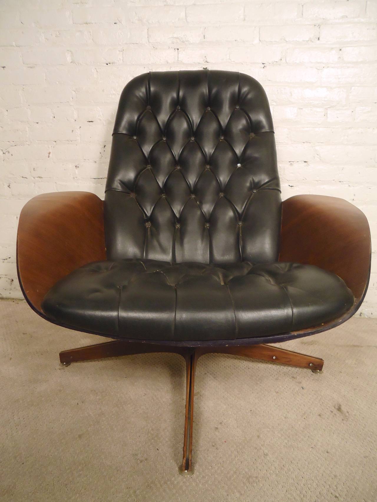 Eames era tufted lounge chair made by Plycraft with attractive bentwood arms and back. Matching ottoman, swivel bases, comfortable vinyl covering.

(Please confirm item location - NY or NJ - with dealer)