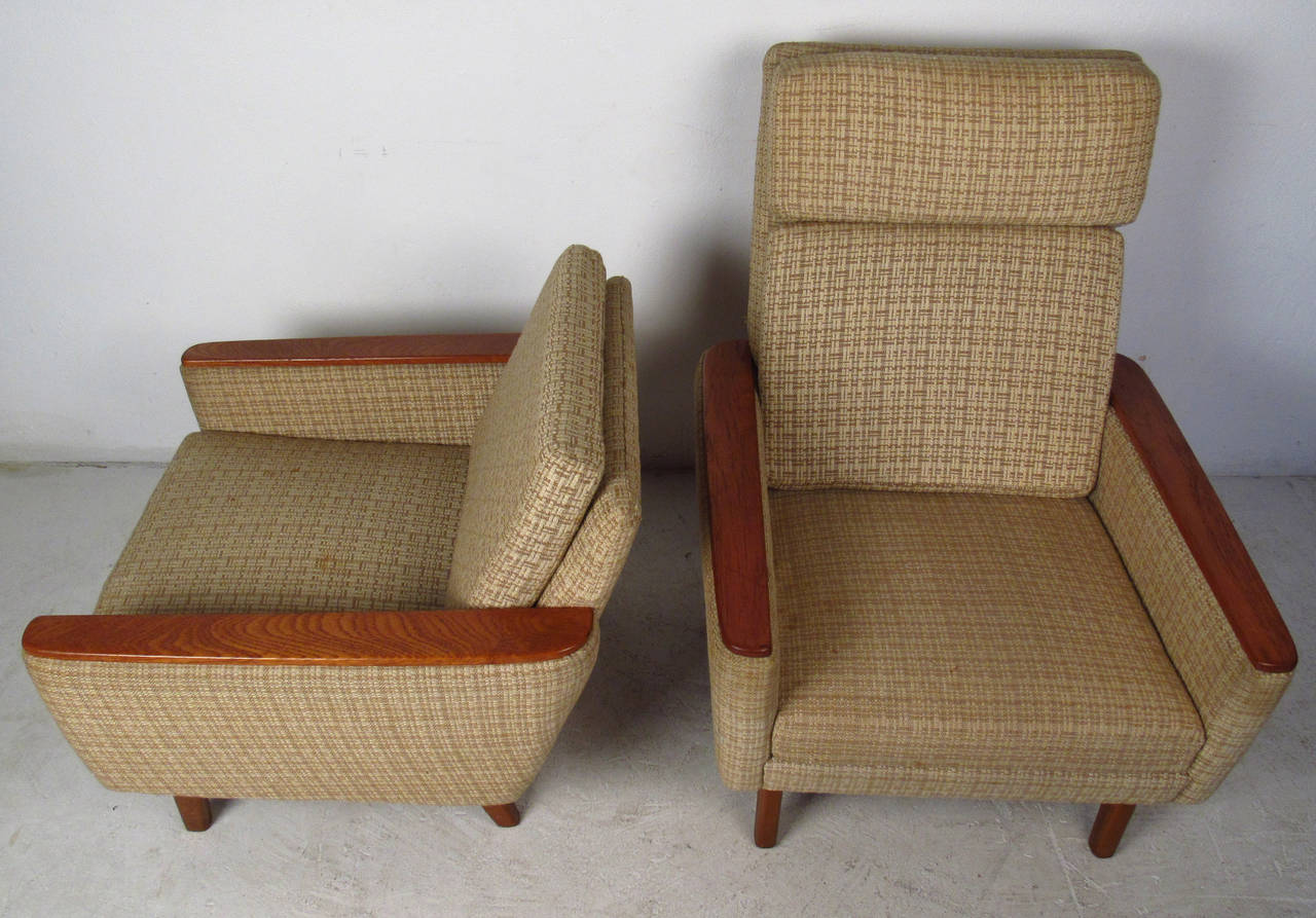 This stylish pair of vintage-modern lounge chairs feature unique Scandinavian Modern design. The teak armrests and hardwood legs add to the mid-century appeal of this matching pair of his and her chairs, made in Denmark.

Dimensions:
29-w 28-d 29-h