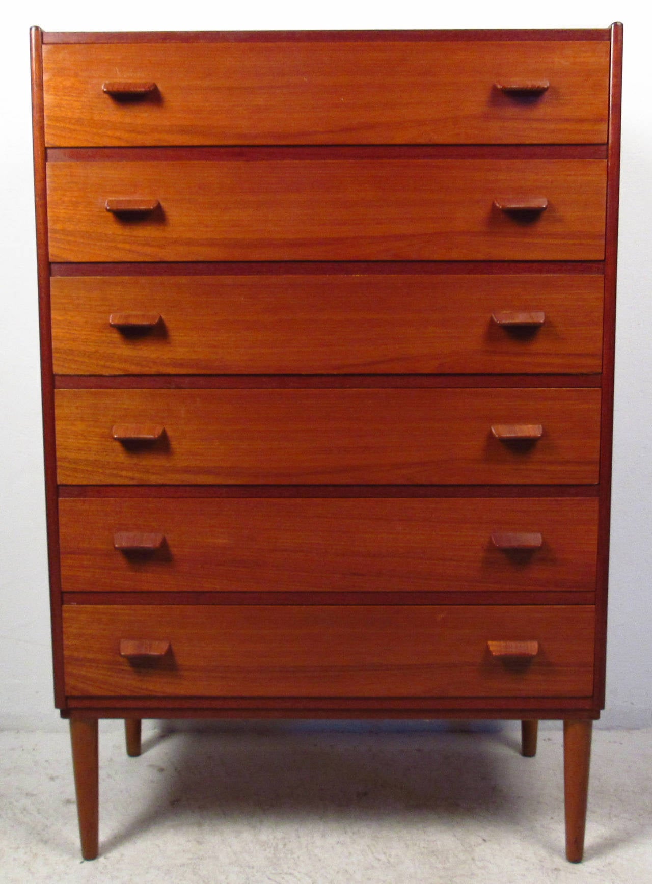 Vintage-modern Danish highboy dresser features six drawers with sculpted handles and beautiful teak grain. Designed by Poul Volther.

Please confirm item location NY or NJ with dealer.