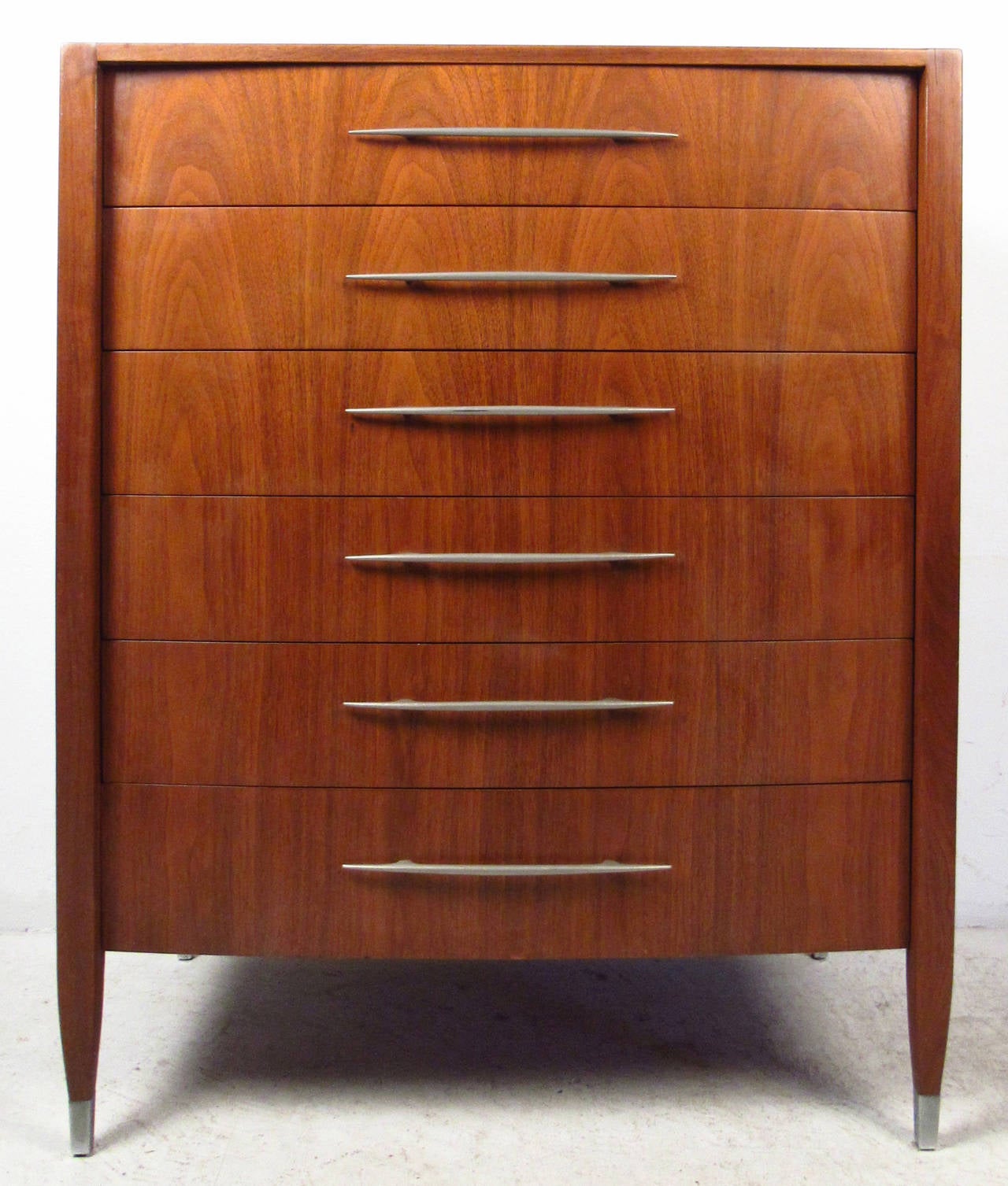 Vintage-modern high boy dresser by Sligh Furniture, features six drawers with unique chrome handles, and sculpted chrome capped feet. This well made case piece ensures plenty of room for storage within its six hefty drawers. The vintage walnut
