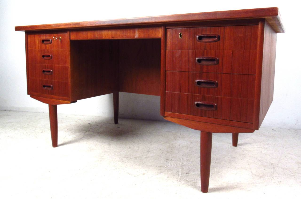 Stylish double-pedestal Danish Modern desk with eight locking drawers on front and storage compartments on back. Please confirm item location (NY or NJ) with dealer.