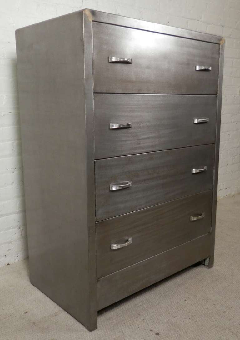 Vintage metal four drawer dresser designed by Norman Bel Geddes for Simmons. Striped to bare metal and lacquered for a striking industrial look.

(Please confirm item location - NY or NJ - with dealer)