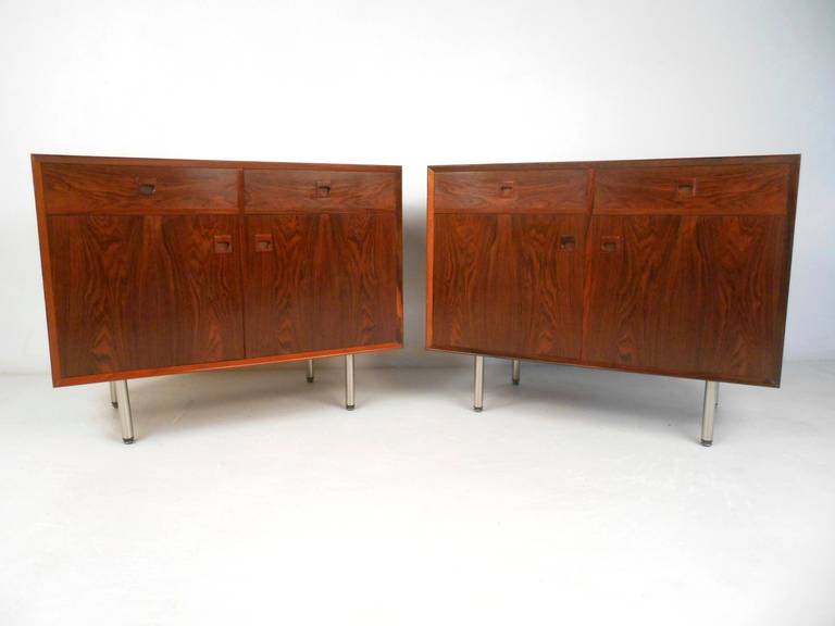 Stylish Scandinavian Modern cabinets in rosewood feature exquisite Danish modern design. Double drawers on top, one with felt lined tray and bottom compartments each contain adjustable shelf. Please confirm item location (NY or NJ) with dealer.