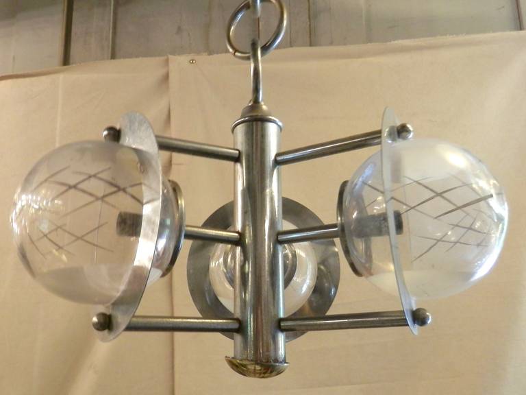 Vintage modern chrome lamp with three glass globes, featuring hand done design of silver decoration and semi frosted glass. Comes with original large ring chain.

Height up to canopy is 33".

(Please confirm item location - NY or NJ - with