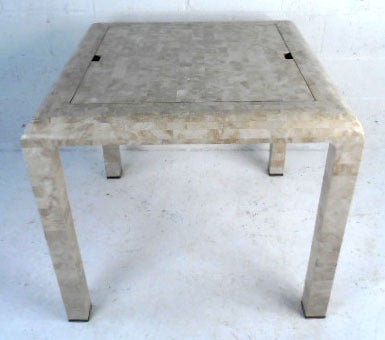 This beautiful vintage gaming table features backgammon, chess/checkers, and a standard table top. With high quality mosaic-like construction for a distinctive look, this table's versatility is beaten only by it's style.