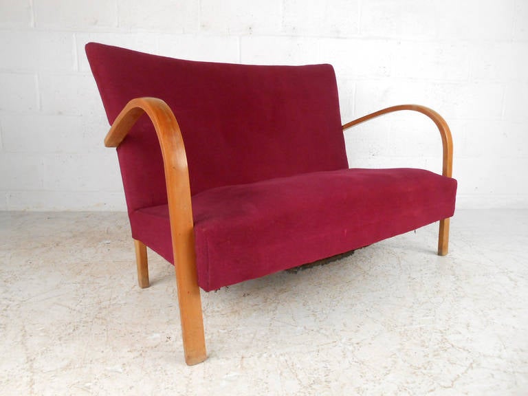 This beautiful midcentury settee is perfectly sized for tight quarters, and wonderful addition to home or business. It's uniquely designed curved bentwood frame makes this truly original and a fantastic compliment to a pair of matching armchairs.
