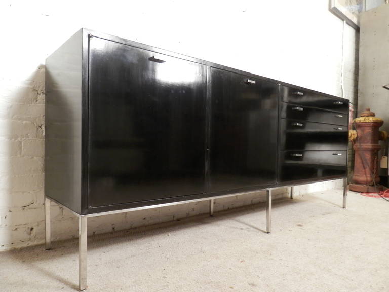 Super sleek long credenza designed by Harvey Probber with accenting polished metal hardware. Two side cabinets and four wide drawers. Makes a great focal point in your office or living room. Simple and streamlined vintage modern design.

(Please