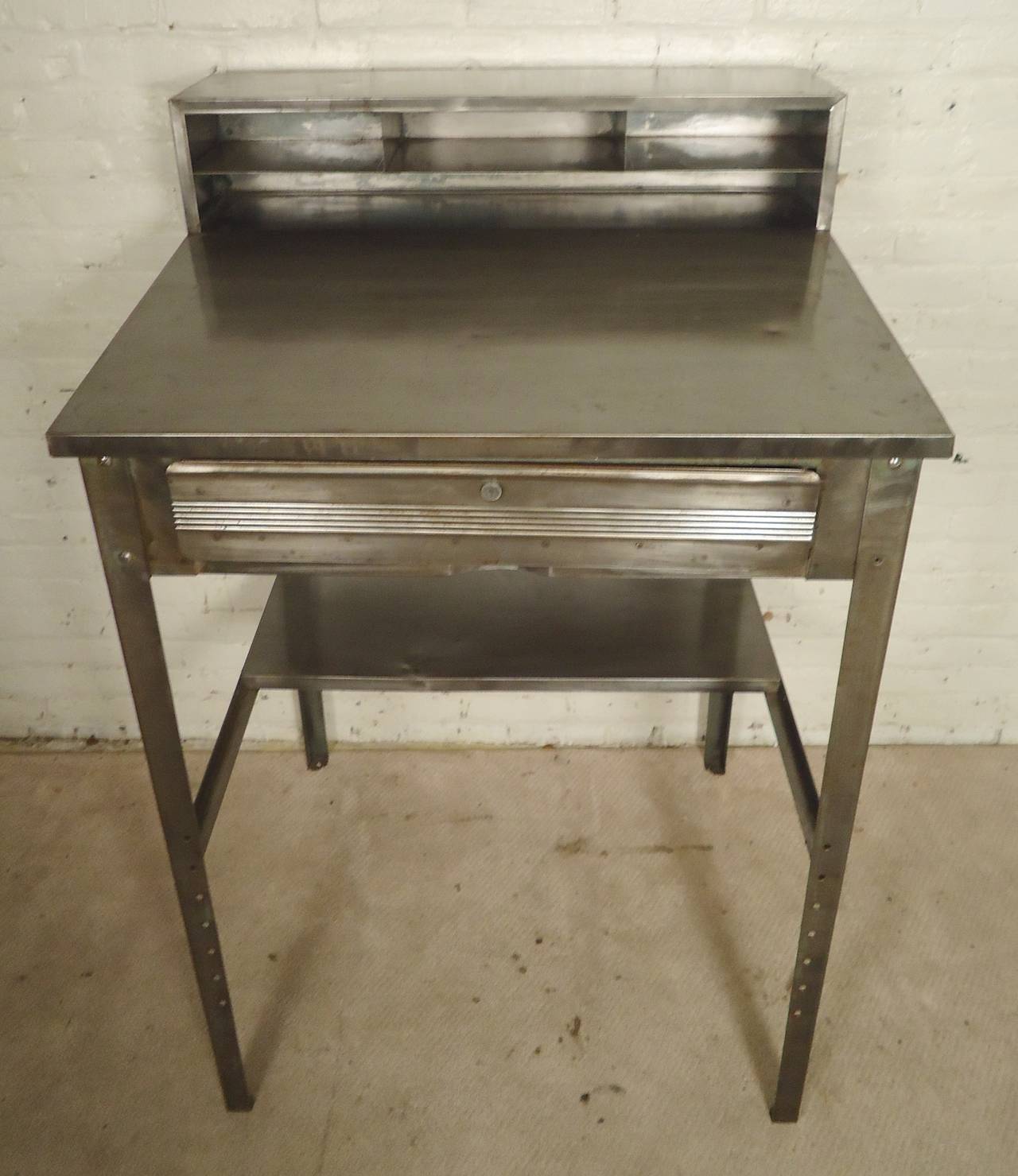 Industrial style tall desk with drawer and top storage. Angled desk space, great for restaurant use or with a drafting stool.
Desk height is 43