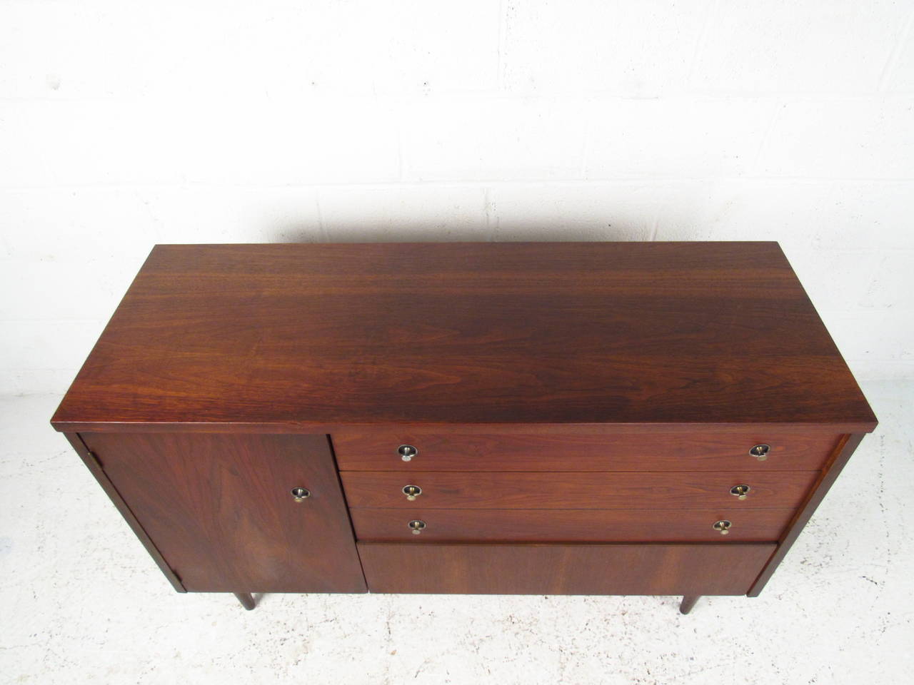 This stylish credenza is the perfect size for compact & stylish storage in any room. Whether used for dinner service, bedroom organization, or as a TV  credenza, this vintage Bassett piece makes an attractive mid-century addition. Please confirm
