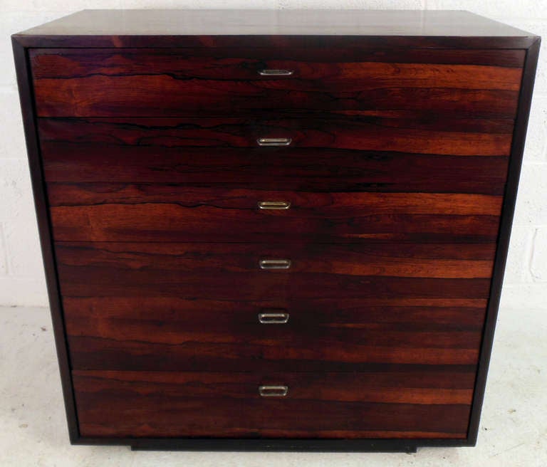 This vintage dresser offers six spacious drawers for storage, and beautiful Rosewood finish. Sturdy construction and unique drawer pulls make this a great option for home or business. Please confirm item location (NY or NJ).