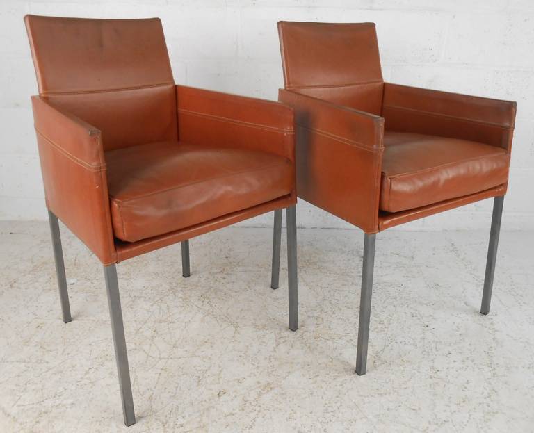 Pair of rust color leather side chairs with square tubular stainless frames by KFF. Please confirm item location (NY or NJ) with dealer.