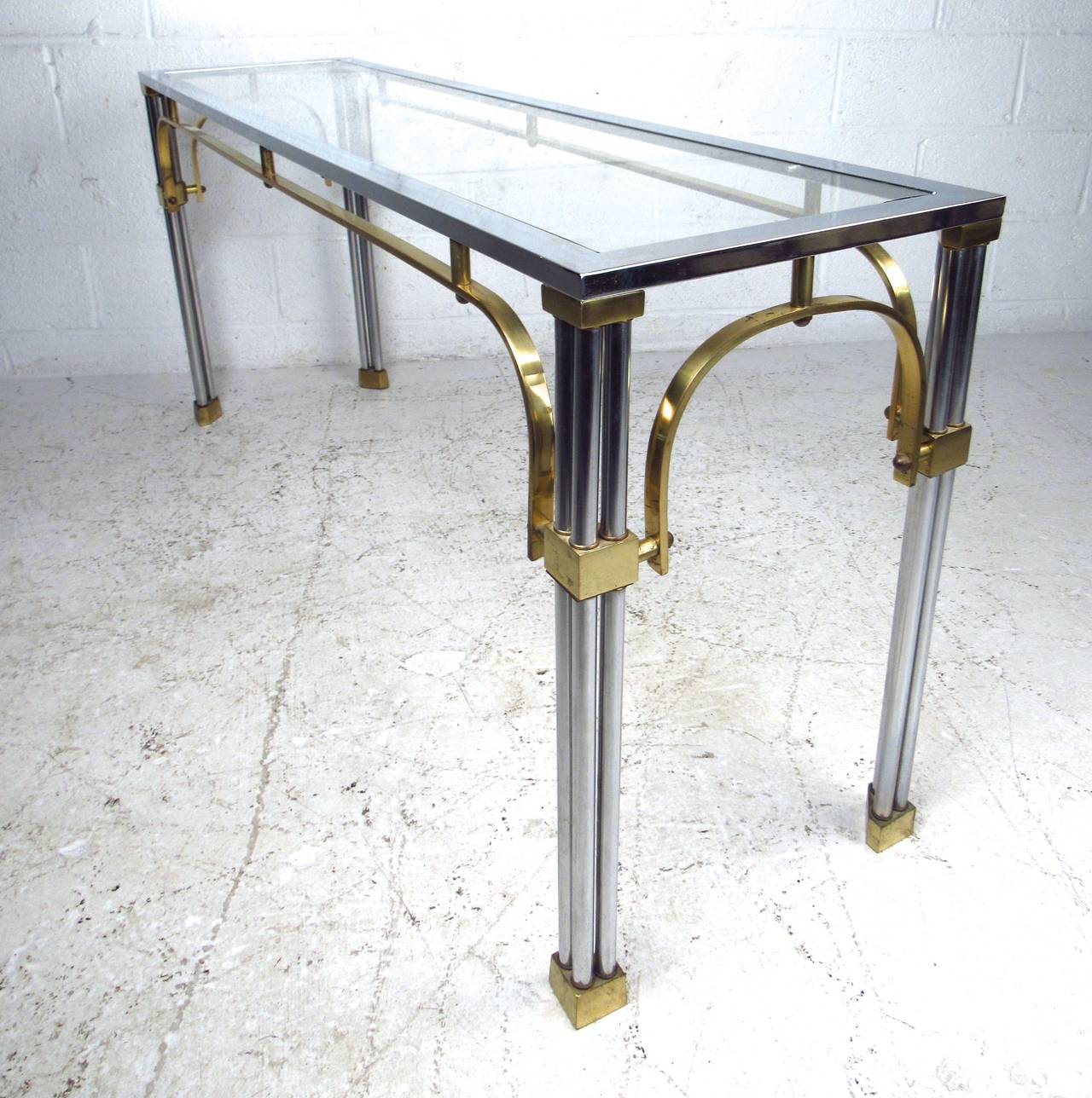 This beautiful vintage hall table features a sturdy chrome frame with ornate brass trim. Perfect size for use behind a sofa or as an entryway table. Wonderfully designed with elements of Maison Jansen and Romeo Rega. Please confirm item location (NY
