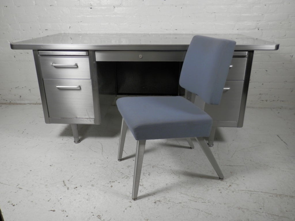 Industrial metal double pedestal desks by Steelcase with great mid-century modern Good Form chair.
We have multiple sets, perfect for stocking an office.
Desk sits on a double pedestal base, each with two drawers and pull out shelf, plus middle