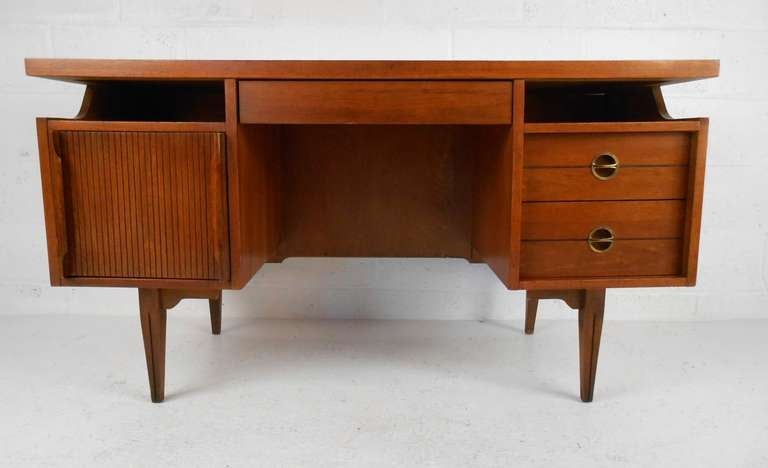 Mid-Century walnut Hooker floating top desk with caned back. Please confirm item location (NY or NJ) with dealer.