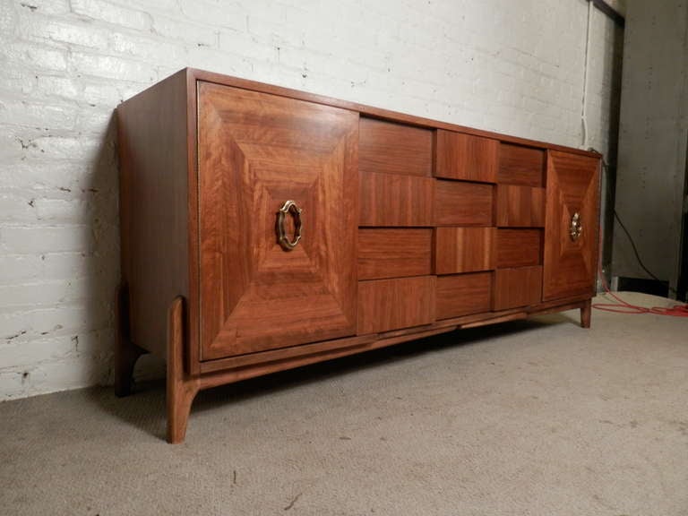 American of Martinsville long dresser with mosaic pattern front. Twelve total drawers, sculpted legs and original brass handles. Great as a bedroom dresser or living room credenza.

(Please confirm item location - NY or NJ - with dealer)