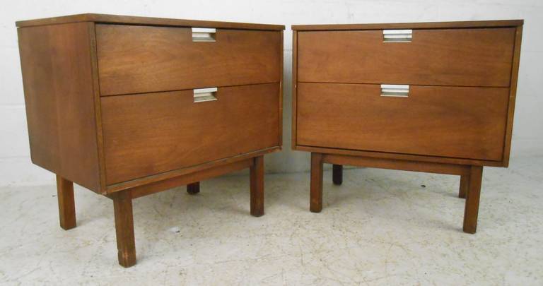 Great pair of midcentury two-drawer nightstands in walnut feature aluminum handles and spacious drawers for bedroom storage. Please confirm item location (NY or NJ) with dealer.