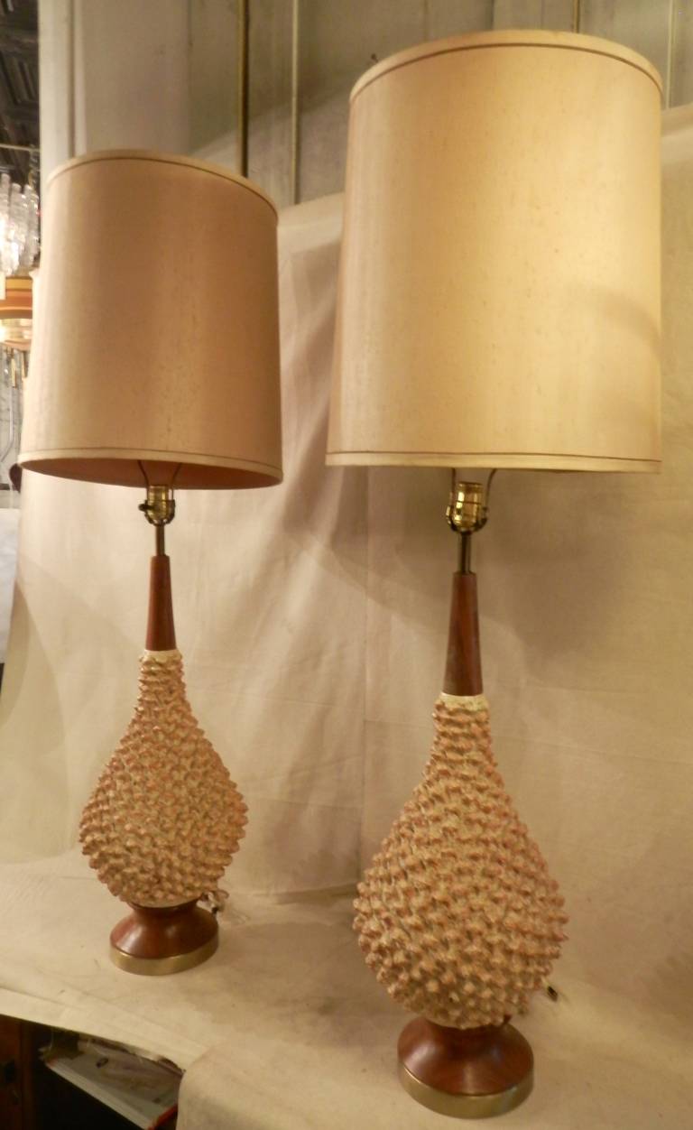 Pair of vintage modern table lamps with a painted plaster body and teak trim. Round pine cone style shape with large vintage shades.
32