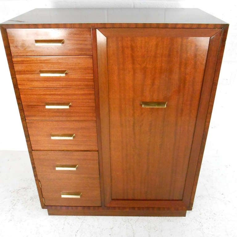 This beautiful mid-century gentleman's chest if a classically designed solution for clothing storage in any setting. With ample drawers and hanging space this versatile cabinet is just what's needed when organization and style are key. Please