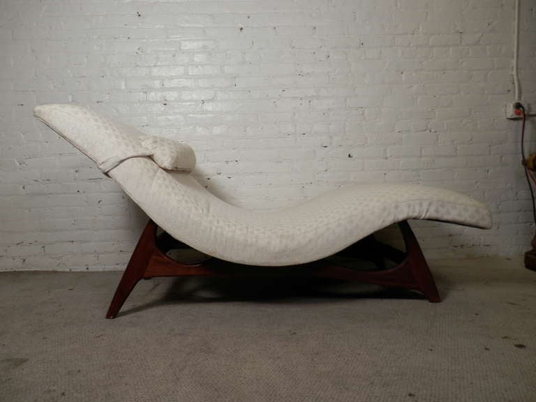Vintage modern chaise lounge with sculpted walnut legs. thick cushion in a wave form with added pillow.

(Please confirm item location - NY or NJ - with dealer)