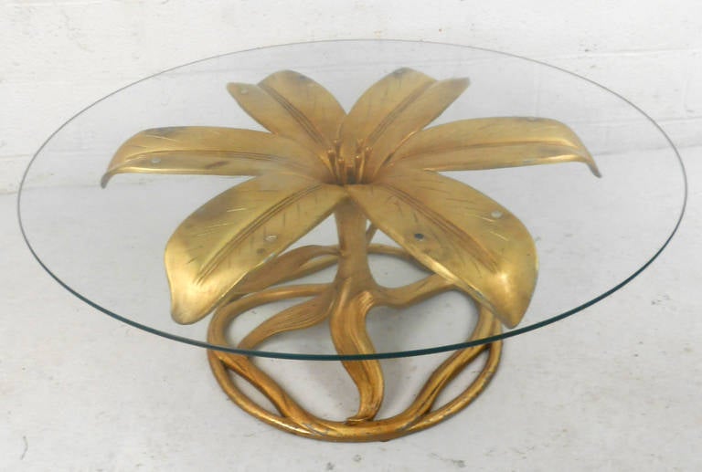 This unique vintage coffee table features a unique gilt finish, and 42 inch diameter glass top. Striking sculptural base in the style of Arthur Court makes a wonderful and eye-catching addition to any seating area. Marked with 
