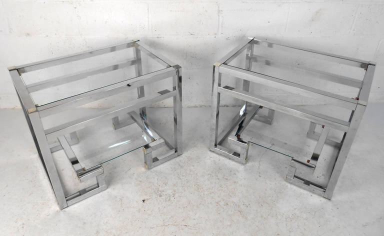 This matching pair of chrome and glass Mid-Century Modern end tables offer a wonderful addition to any space. Unique two-tier glass tops only accent the beauty of the pieces unique design. Please confirm item location (NY or NJ).