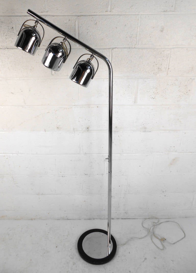 This vintage floor lamp features three pivoting lamps mounted on a beautiful and substantial floor lamp. Fantastic chrome finish and unique shape make this versatile lamp a great addition to any room, Please confirm item location (NY or NJ).