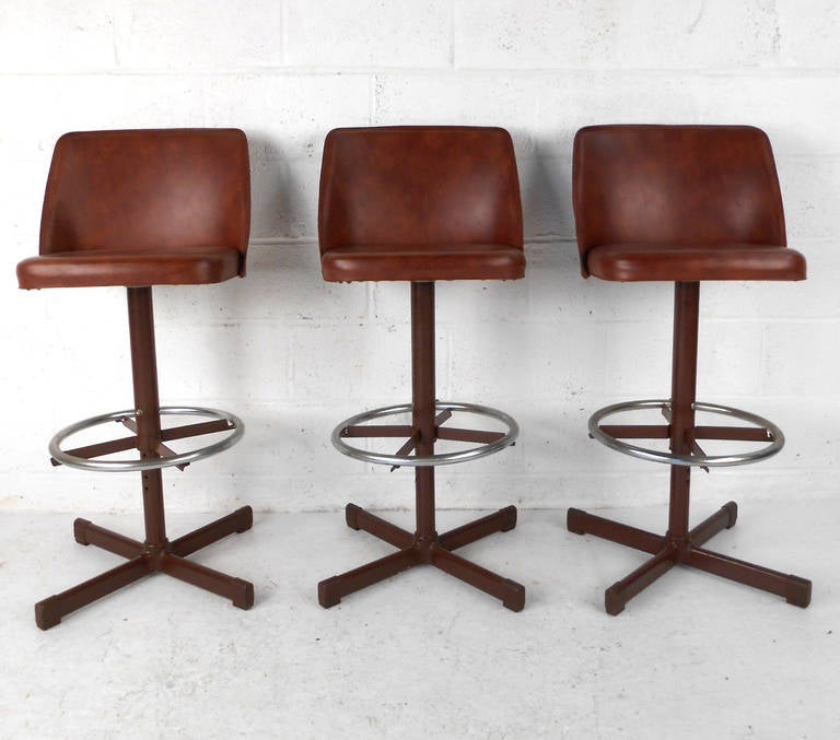 This unique set of adjustable height bar stools feature swivel seats, chrome footrest, and vintage vinyl seats. Perfect for home or business, counter or bar. Please confirm item location (NY or NJ).
