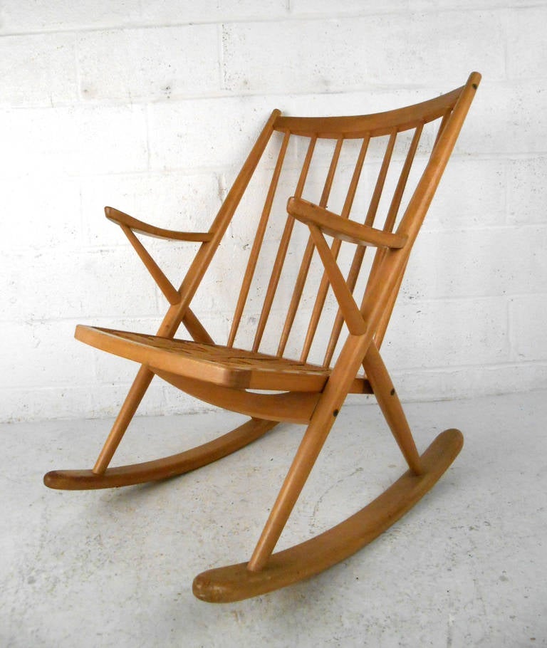 This unique vintage rocking chair features beautifull tapered spoke back and frame set on wide sturdy rocking base. Strap seat for comfort, needs new cushion. Please confirm item location (NY or NJ).