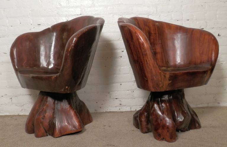 Pair of vintage sculpted chairs, made of solid wood. Carved to make a comfortable shell armchair with a swivel tree trunk base. One of a kind look. Great for indoor or outdoor use.

(Please confirm item location - NY or NJ - with dealer).