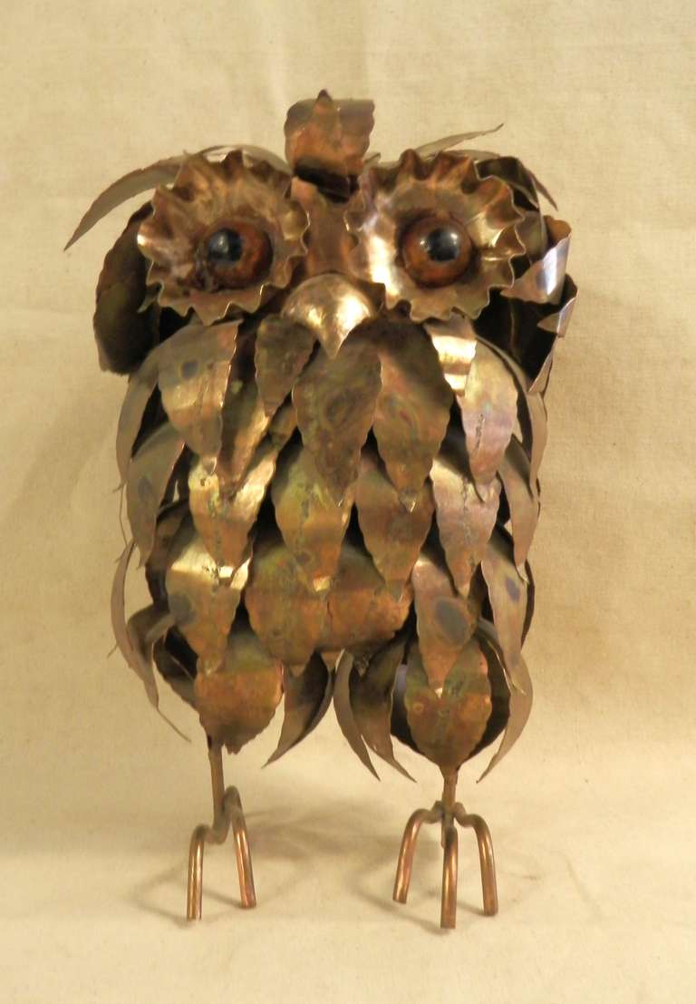 Charming standing owl made from hammered brass. Layers of metal sheets act as his feathers to form his body and can be placed in a standing or sitting direction for different looks. Large amber colored eyes.

(Please confirm item location - NY or